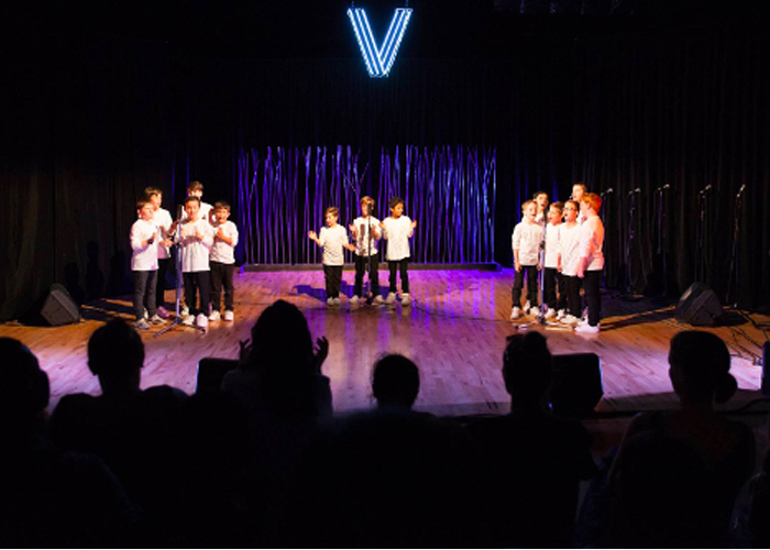 A group of kids performing on stage