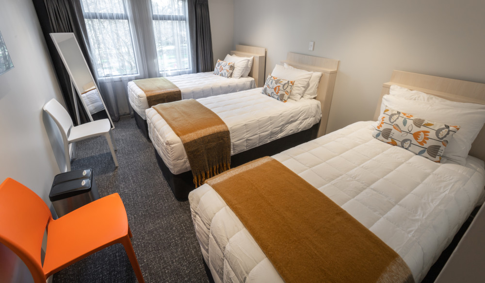 Three single beds in a Classic Triple Room at Hotel Give