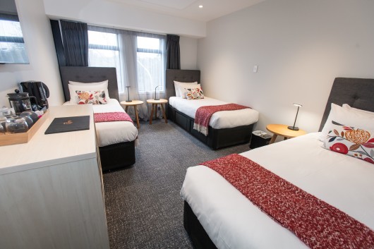 Three single beds in a Deluxe Triple room at Hotel Give