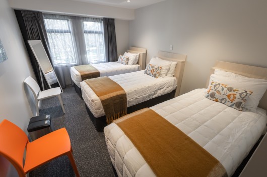 Three single beds in the classic triple room at Hotel Give